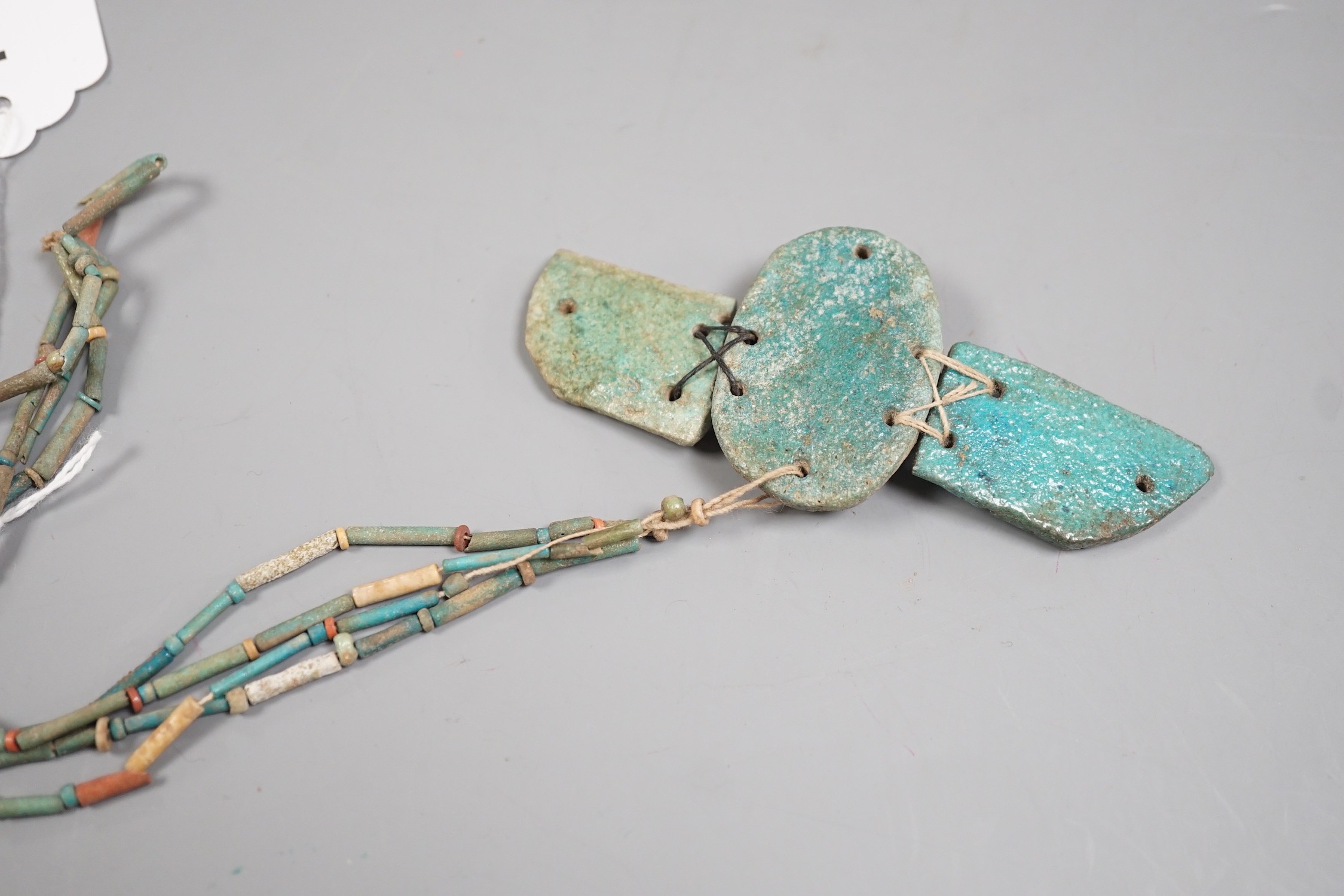 An Egyptian turquoise glazed faience scarab pendant, and cylindrical beads, probably New Kingdom